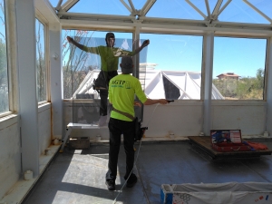 Greg and Tristen Spencer applying window tint to SAM at Biosphere 2