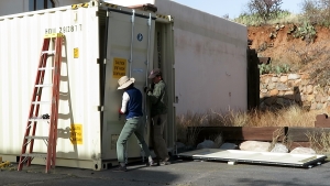 Cooleen Cooley, Kai Staats removing door from shipping container, SAM at Biosphere 2