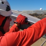 Kai Staats removing an old panel from the Mars yard roof at SAM, Biosphere 2