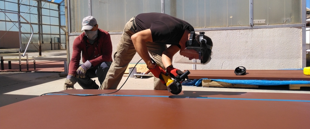 Kai cuts a steel panel at SAM, Biosphere 2