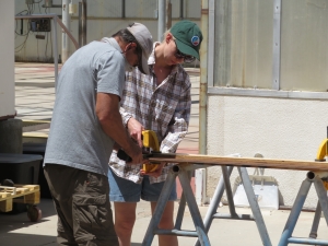 Anastasiya Stepanova working with John Z to cut cork flooring for SAM at Biosphere 2