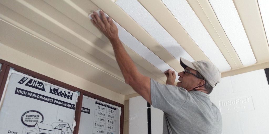 John Z installing insulation panels in the SAM Workshop at Biosphere 2