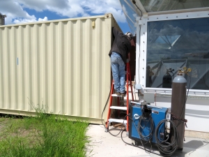 Chharlie welding the 20' to TM interface at SAM, Biosphere 2
