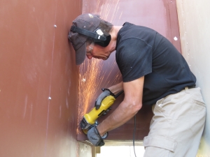 Kai grinding heads of sheet metal screws on SAM at Biosphere 2