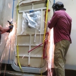 Nathan Schmit, Kai Staats salvaging an original pressure door from Biosphere 2 for SAM.