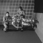 A test subject being suited up for studies on the Reduced Gravity Walking Simulator at NASA Langley Research Center, 1966.
