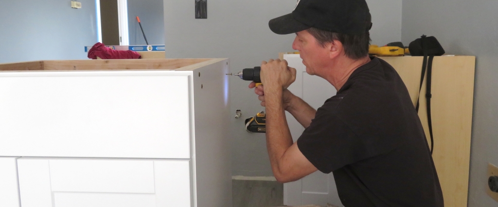 Kai Staats reinforcing a cabinet for the SAM Operations Center kitchen