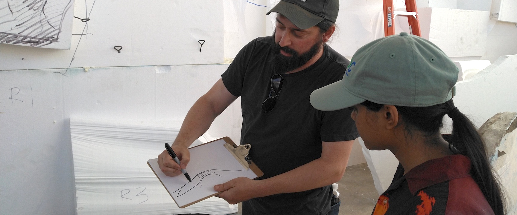 University of Arizona planetary geologist Dr. Christopher Hamilton guides Arizona State University planetary geology student Tasha Coelho in the design of the Mars yard at SAM, Biosphere 2