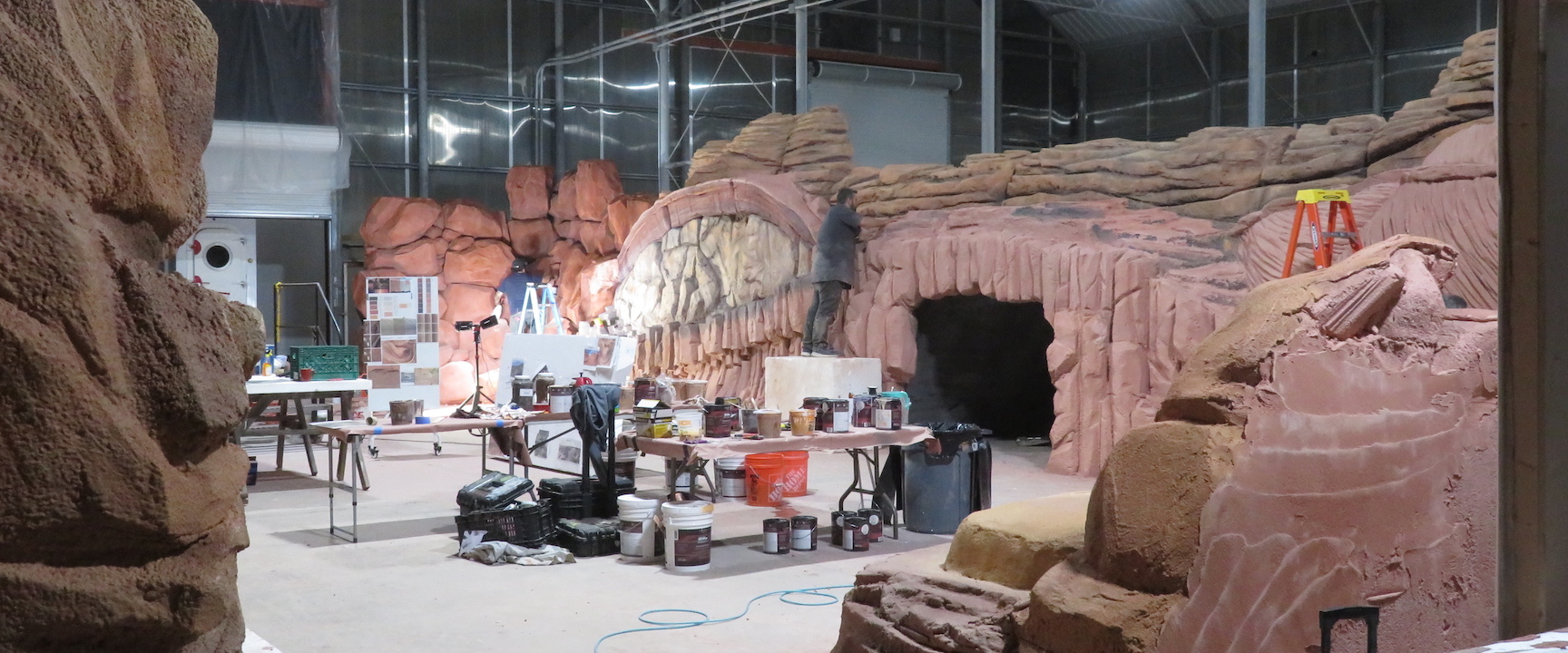 Painter Danni gives bold, three dimensional form to the carved, simulated stones at SAM, Biosphere 2