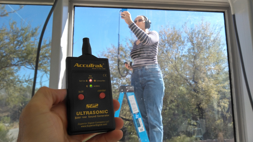 Luna Powell using an ultrasonic leak detector at SAM